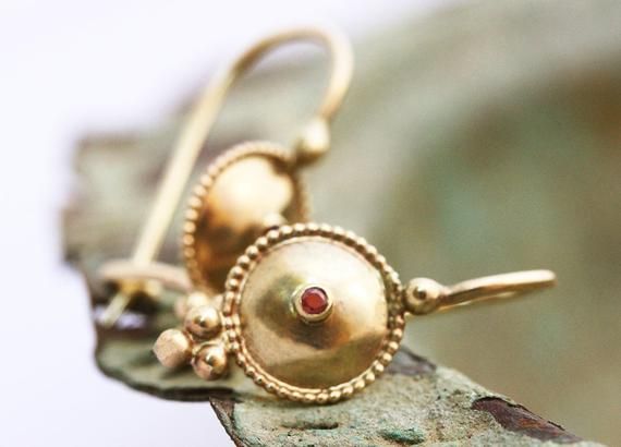 Exquisite, antique-style very small ruby and 14k, 18k or 22k solid gold hook drop earrings. These amazing drop earrings have a decorated domed disc and a tiny red ruby set in the middle of it. At the bottom of the disc on each earring, there are three gold dots that add character to these boho earrings. These earrings are elaborate and delicate but still very noticeable. They have a unique eye-catching boho look that will go with and upgrade any outfit.Ruby is the birthstone of July and is consi Ruby Earrings Gold, Gold Earrings Bridal, Boho Wedding Ring, 22k Gold Earrings, Ruby Set, Stacked Wedding Rings, Gold Bridal Earrings, Yellow Gold Wedding Band, 18k Gold Earrings