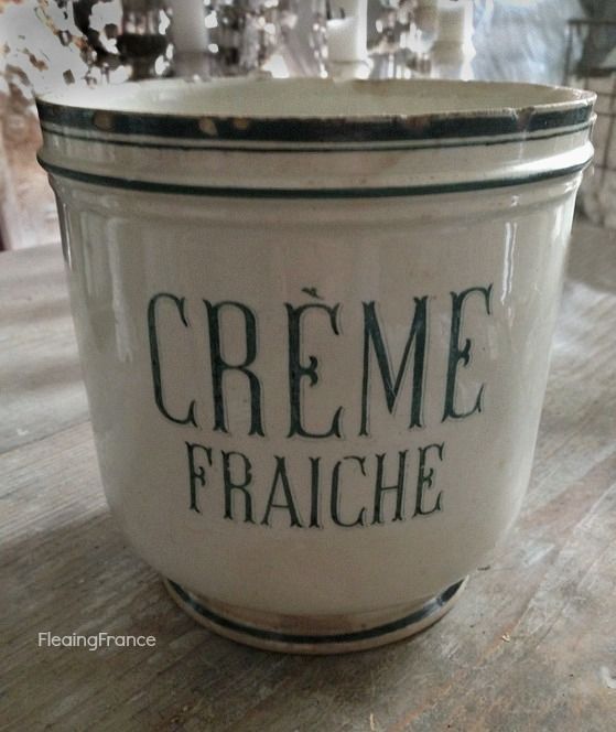 a creamer with the words creme fraiche written in black ink on it