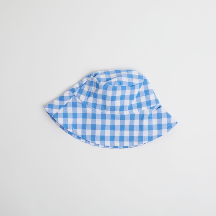 Introducing the Gingham Sunhat! Keep your little one looking stylish and shaded with this fun and fashionable cornflower blue baby sun hat, complete with checkered gingham print that your baby will love. Perfect for a day at the beach or a stylish stroll in the park. Shade in style! Fits ages 6 - 12 months Playful Blue Hats With Upf 50+, Playful Blue Sun Hat For Summer, Blue Hats With Uv Protection For Playtime, Blue Uv Protection Hats For Playtime, Blue Summer Sun Hat For Playtime, Blue Sun Hat For Summer Playtime, Playful Blue Wide-brim Sun Hat, Playful Blue Sun Hat For Playtime, Playful Blue Wide Brim Sun Hat