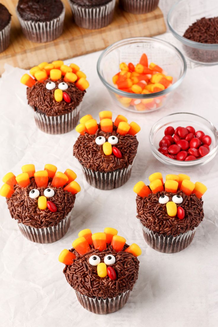 cupcakes decorated with chocolate frosting and candy in the shape of a turkey