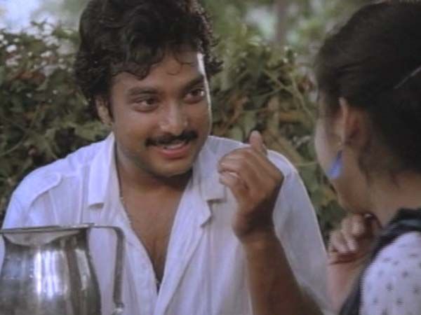 a man with a moustache on his face talking to a woman holding a pot