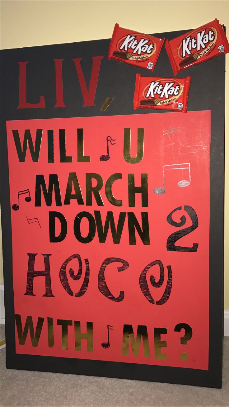 a sign that says will u march down aco with me? and two candy bars