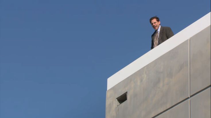 a man standing on top of a tall building