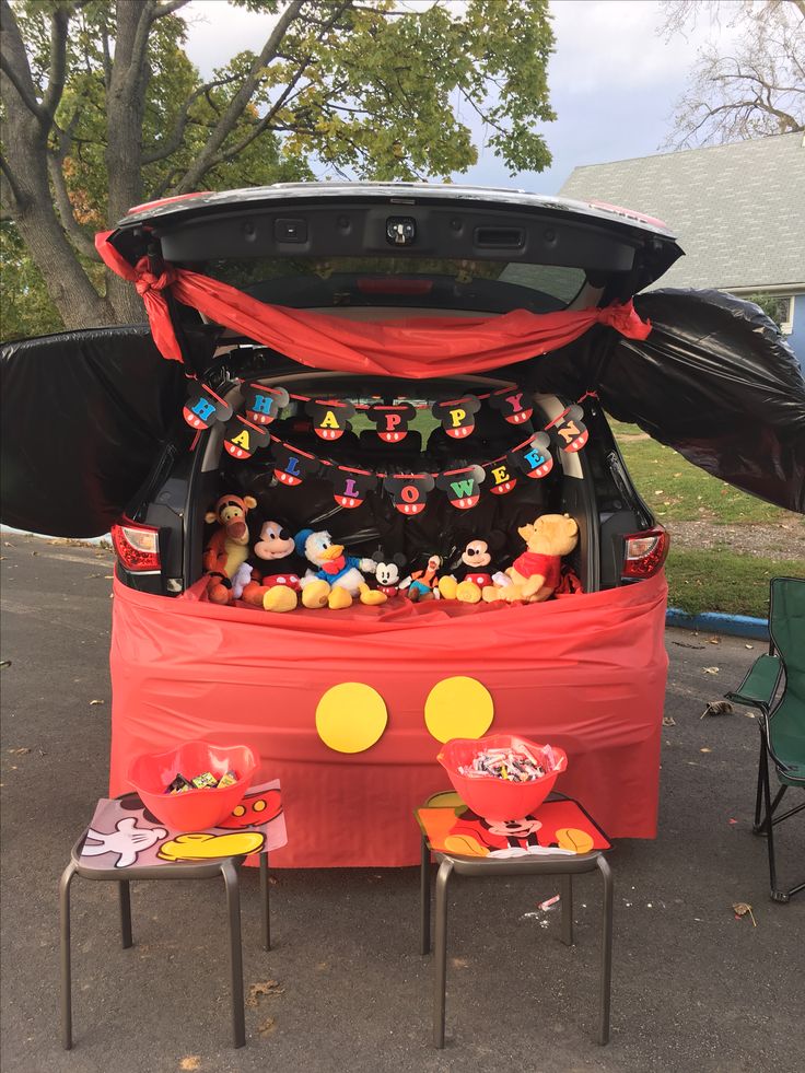 the trunk of a car is decorated with mickey mouse decorations and other items for sale