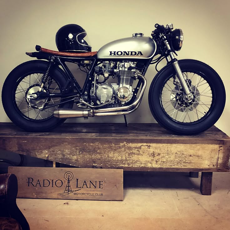 a motorcycle is sitting on a wooden stand