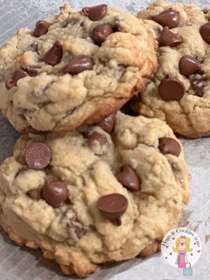 three chocolate chip cookies sitting on top of each other