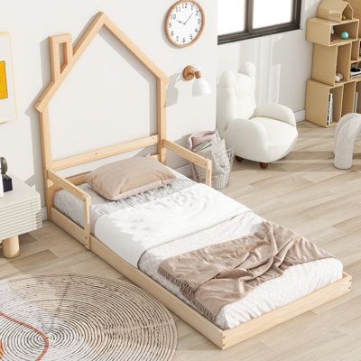 a bedroom with white walls and wooden furniture in the room, including a bed frame