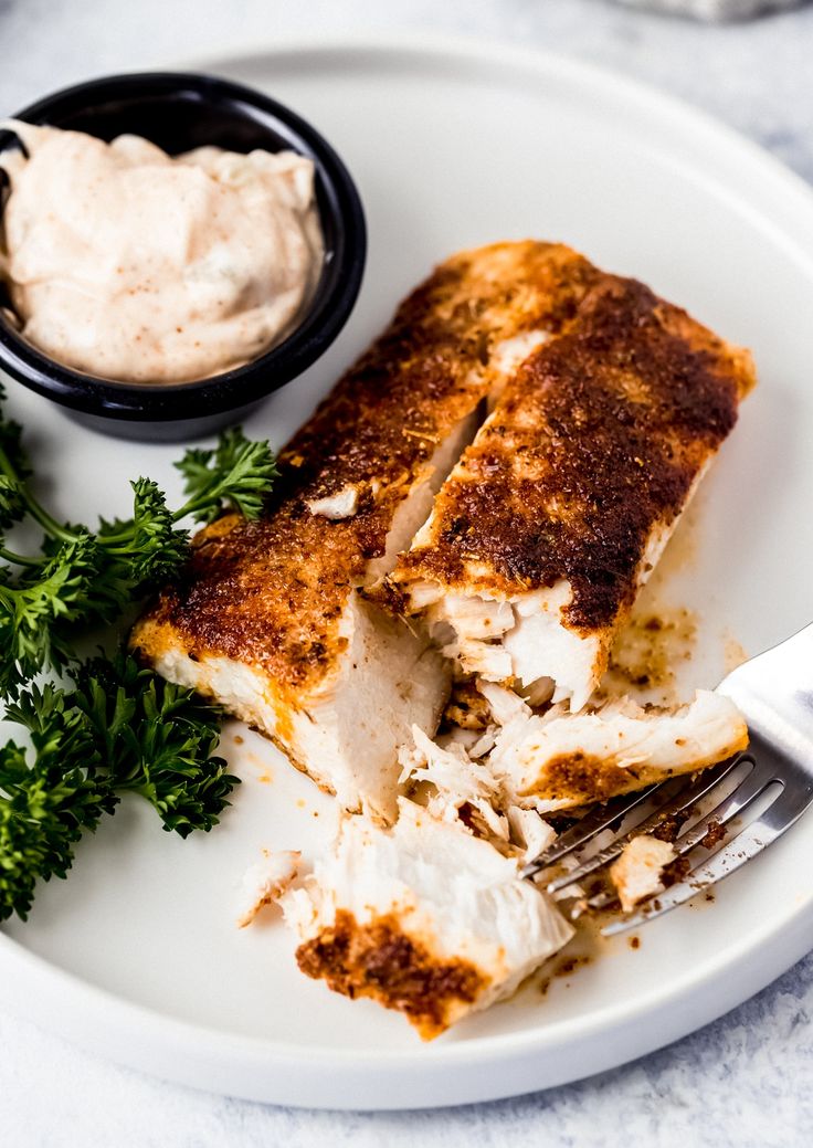 a white plate topped with food and a fork