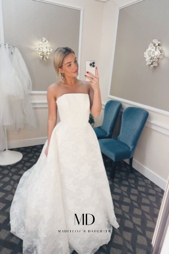 a woman taking a selfie in a wedding dress