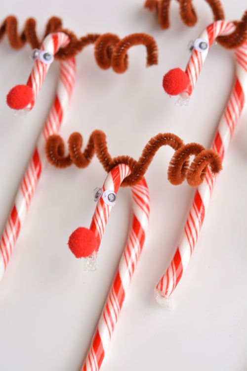 some candy canes are arranged in the shape of a heart on a white surface