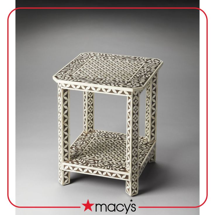 a white table with an intricate design on it's top and bottom, in the shape of a basket