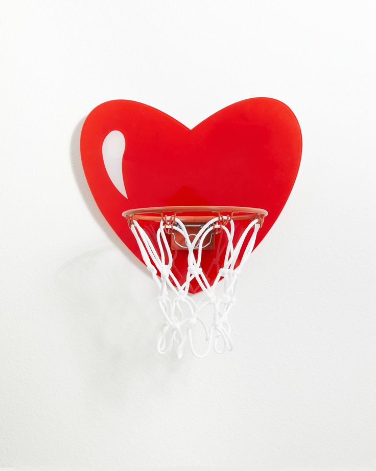 a heart shaped basketball hoop hanging on the wall