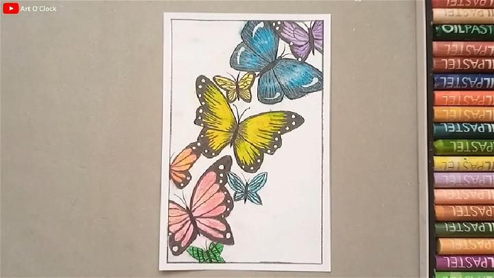 a book with some colored pencils next to it and an image of butterflies on the cover