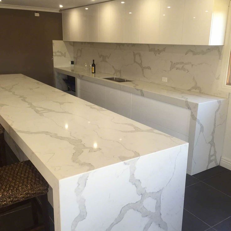 a white marble counter top in a kitchen