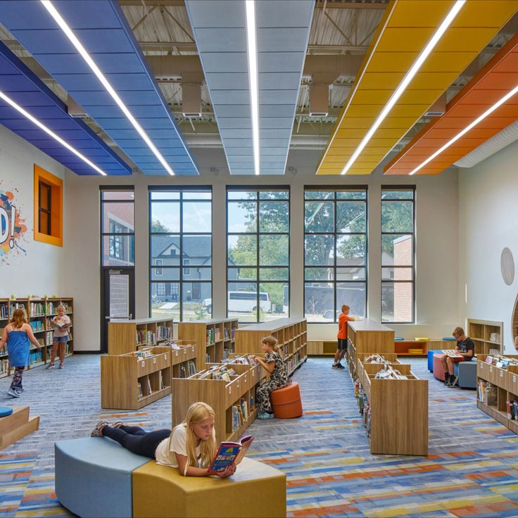 the children are reading in the large library