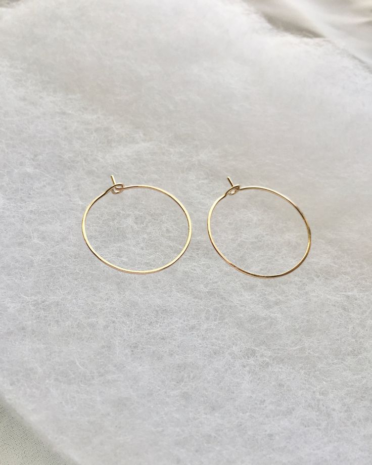 Keep your look sleek and polished with these classic, thin hoop earrings. Effortlessly pair these simple everyday hoops with any outfit for any occasion. An essential, go-to staple to have in your collection. Available In Sterling Silver, 14k Gold Filled or 14k Rose Gold Filled. Details: Simple and Delicate Medium Hoop Earrings Approximately 1" In Diameter Minimal Thin Wire Hoops Lightweight For Comfort Slightly Hammered Texture Design ★ JEWELRY CARE ★To extend the lifecycle of your jewelry and Minimal Choker, Hoop Earrings Medium, Delicate Stacking Rings, Maybelline Falsies, Jewelry Minimal, Simple Gold Earrings, Medium Hoop Earrings, Design Jewelry, Texture Design