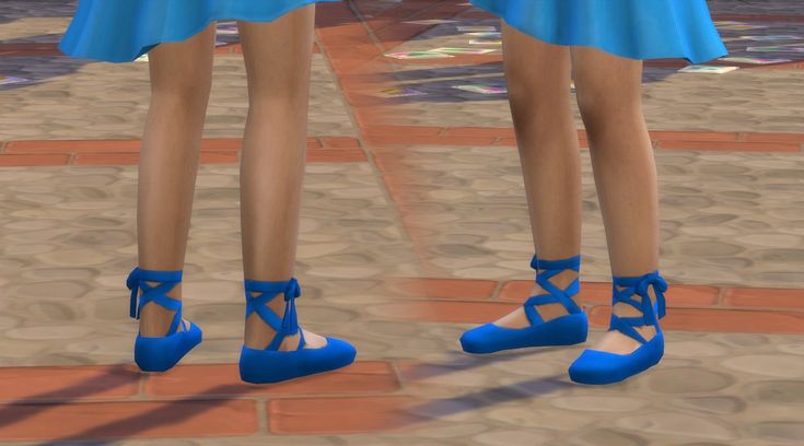 two women in blue high heels standing next to each other