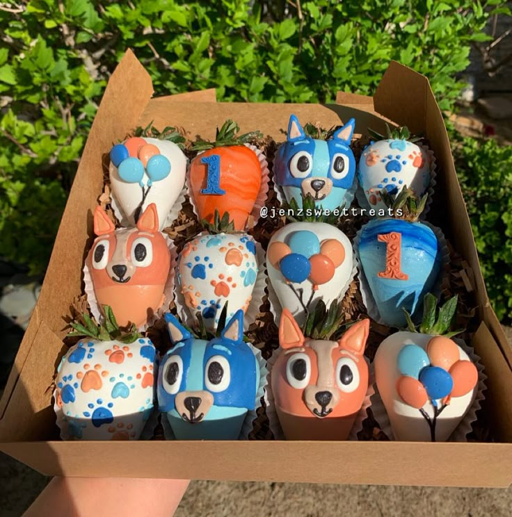 a box filled with cupcakes decorated like animals