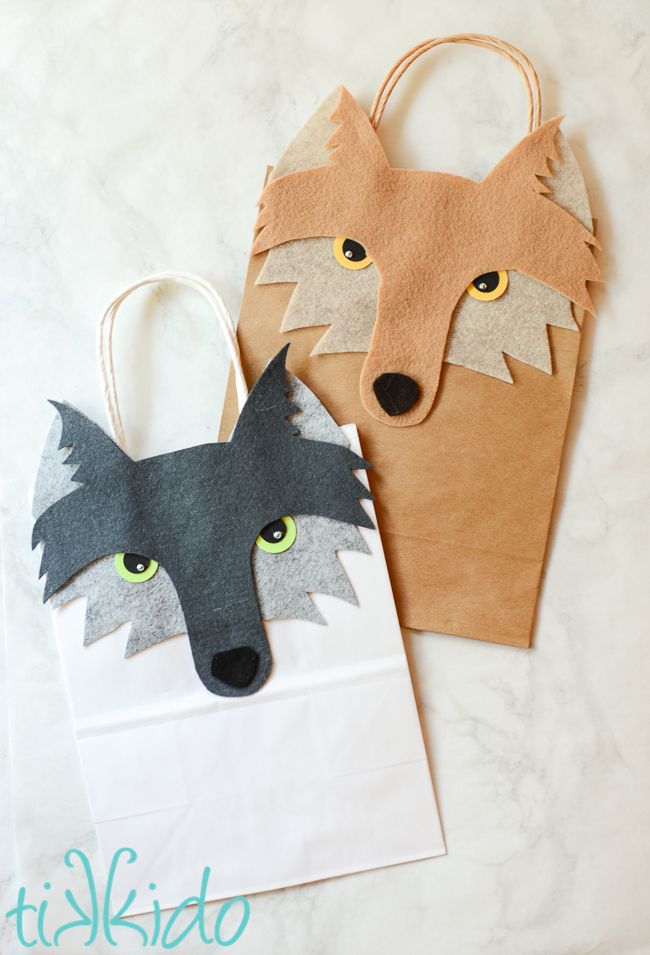 two paper bags made to look like animals with the words wolf gift bag on them