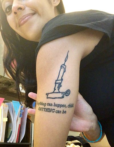 a woman with a tattoo on her arm that reads nothing can happen, anything can be