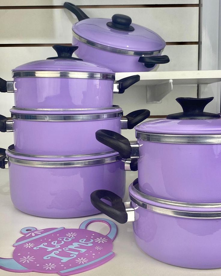 purple pots and pans are sitting on the counter