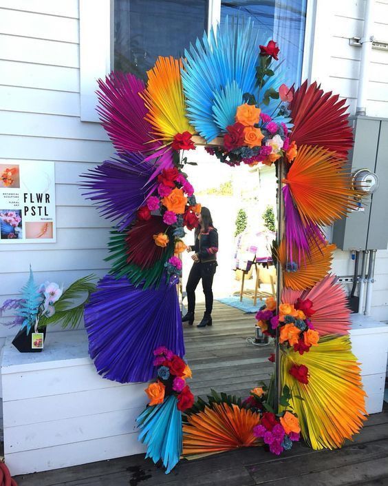 there is a colorful mirror with flowers on it and a person standing in the background