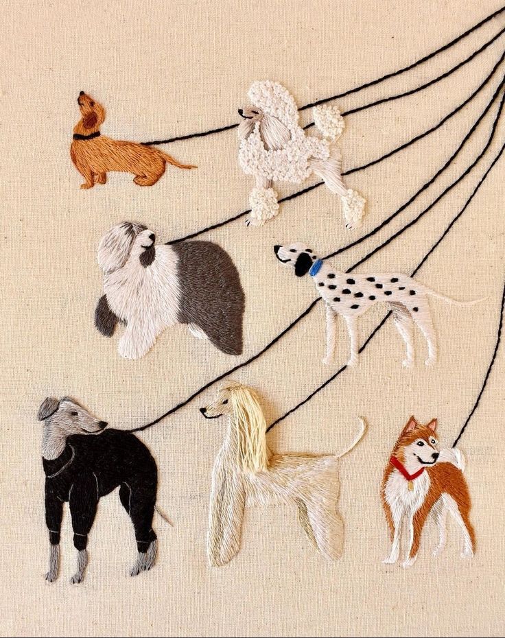 a group of dogs hanging from strings on a wall