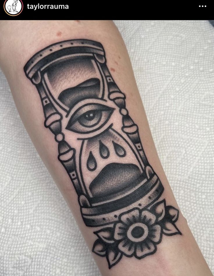 an all seeing tattoo on the arm and leg, with an hourglass in it