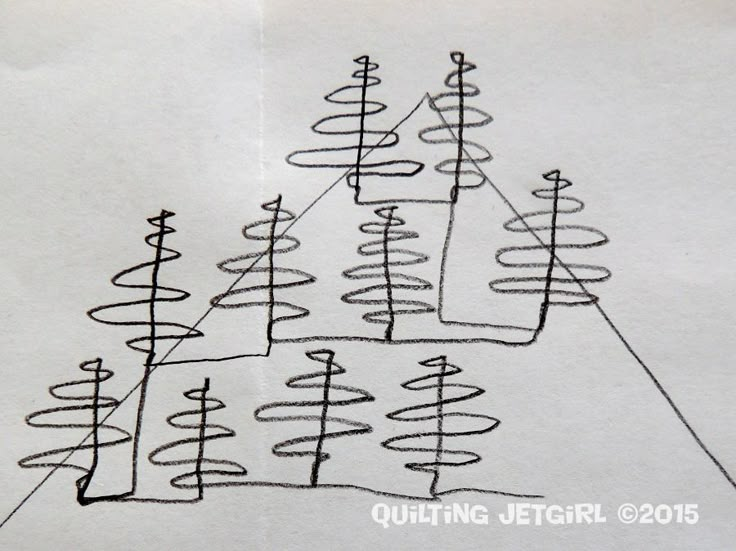 a drawing of several trees on a piece of paper that is drawn with black marker