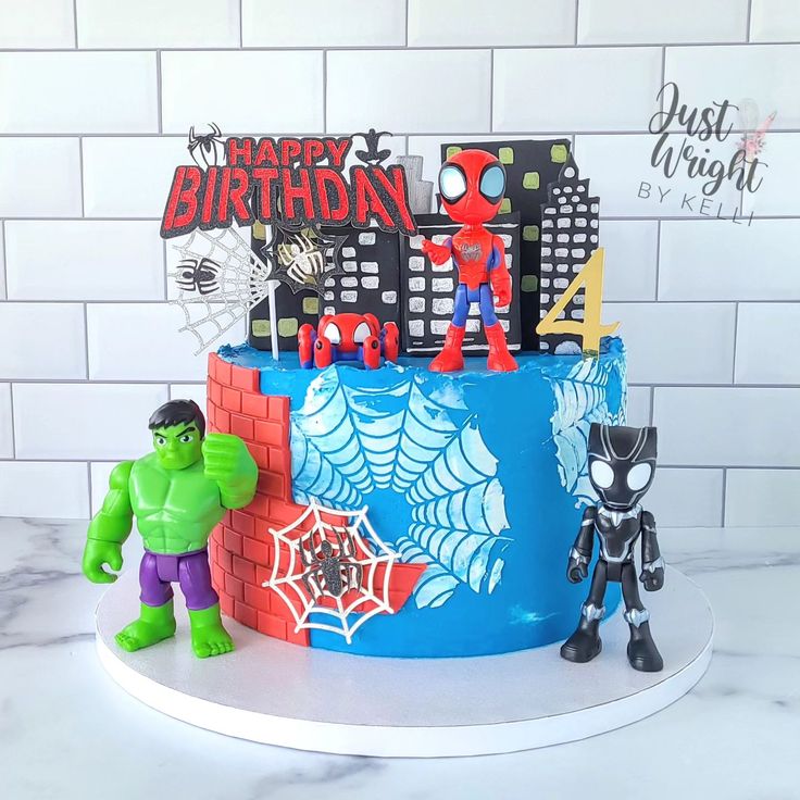 a birthday cake decorated with the hulk and spider - man figures