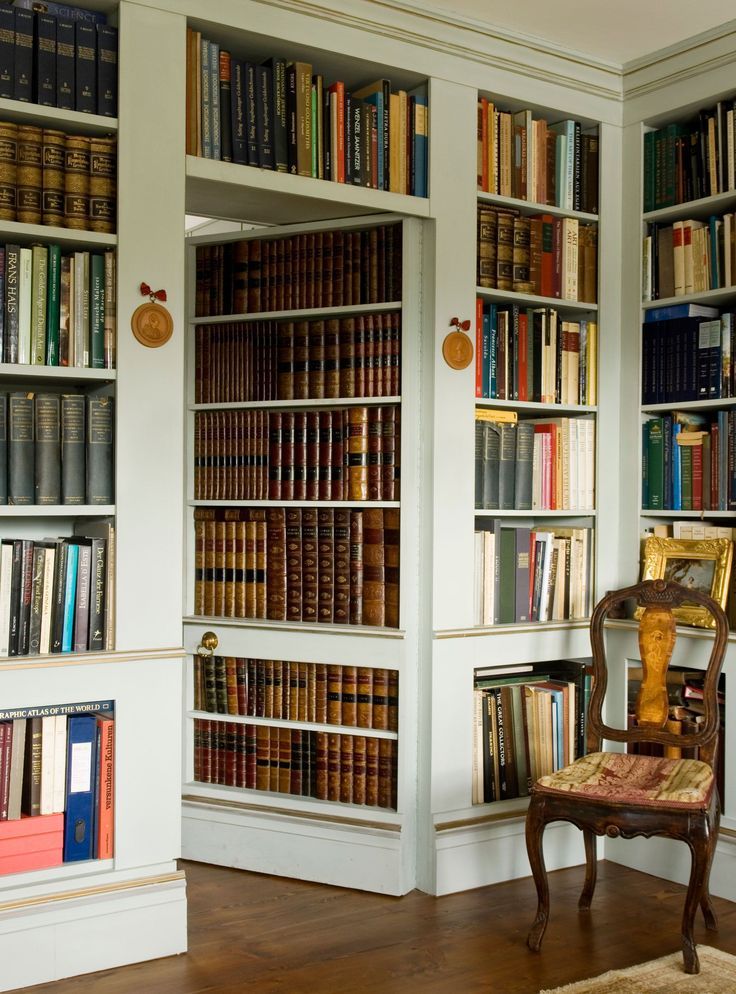 a chair sitting in front of a bookshelf filled with lots of books