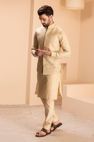 Light gold sleeveless bundi with all over bahar bloom embroidery. Paired with a full sleeves kurta and an Aligadhi pant. - Aza Fashions Designer Chanderi Nehru Jacket Fitted, Fitted Nehru Jacket With Gota Work For Navratri, Fitted Chanderi Nehru Jacket For Designer Wear, Traditional Sleeveless Kurta For Reception, Fitted Chanderi Nehru Jacket Straight Kurta, Fitted Chanderi Bandhgala For Designer Wear, Traditional Sleeveless Bandhgala With Chikankari Embroidery, Designer Nehru Jacket With Gota Work And Traditional Drape, Fitted Chanderi Nehru Jacket With Traditional Drape