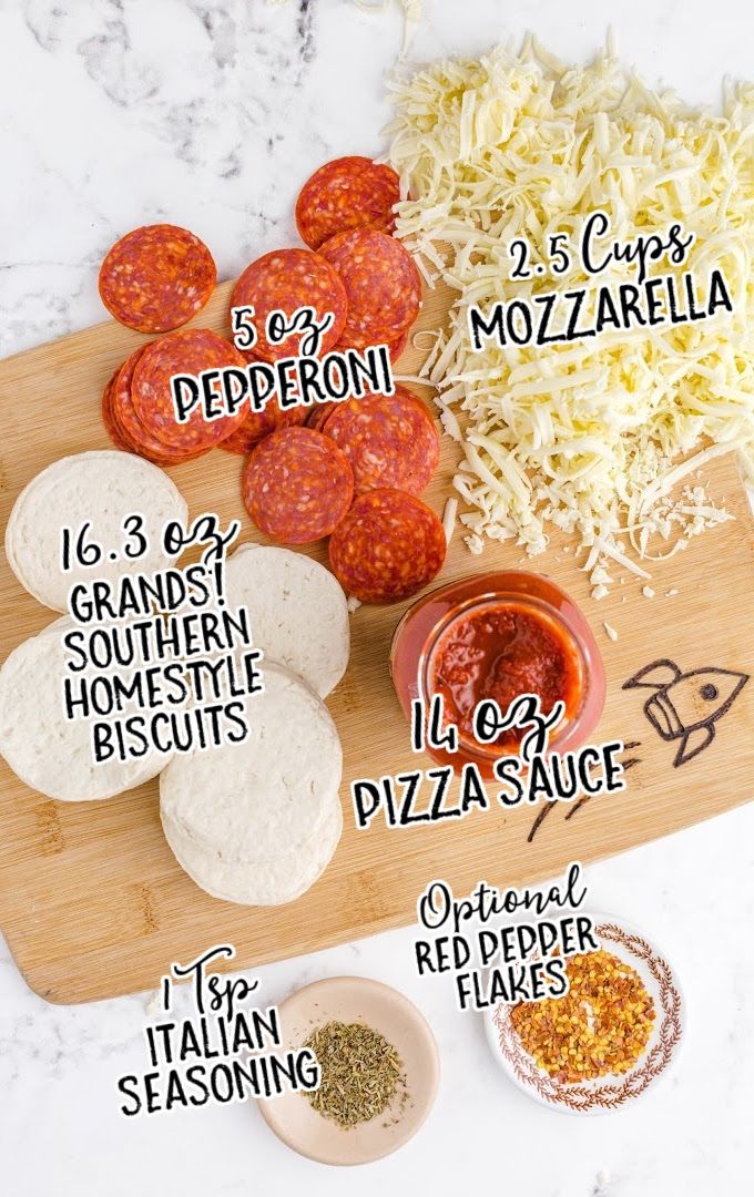 the ingredients to make pizza are shown on a cutting board, including cheese and pepperoni