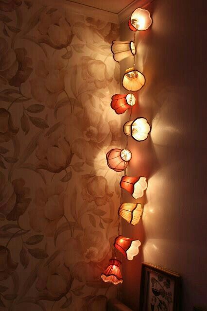 a wall with some lights hanging from it's sides and on top of the wall