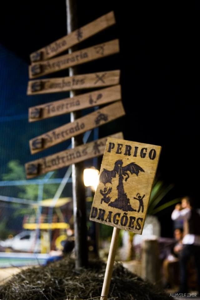 a sign that is sitting on top of some hay in front of a street light