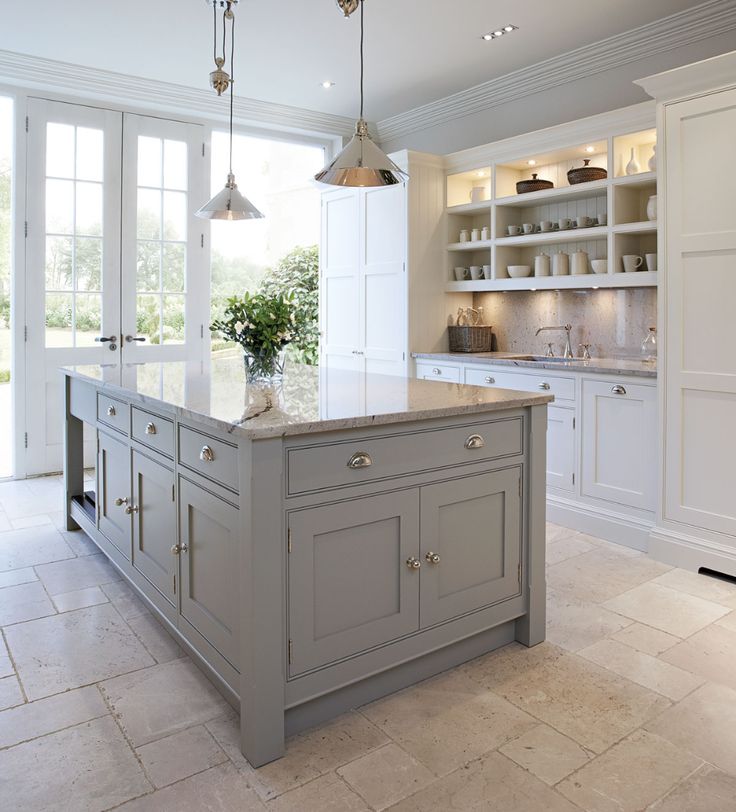 a large kitchen with an island in the middle and lots of cabinets on both sides