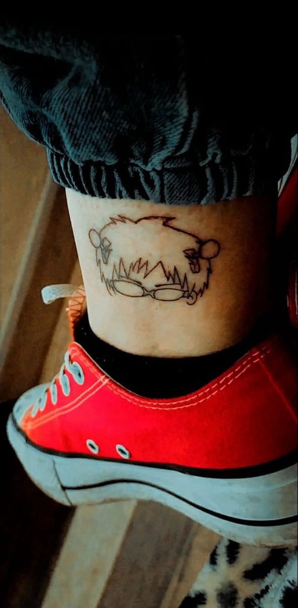 a woman's foot with a tattoo on her ankle and an animal in the middle