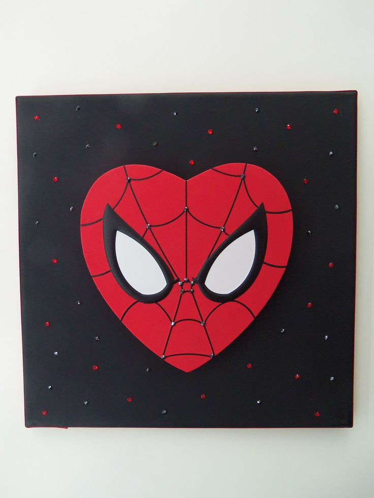 a heart shaped clock with spiderman's face on it