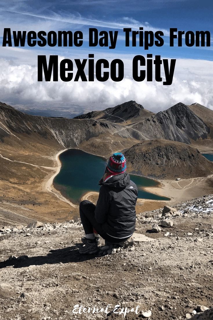 a person sitting on top of a mountain looking out over a lake and mountains with the words, awesome day trips from mexico city