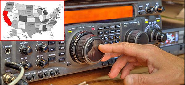 a radio receiver with a map of the united states on it and a hand pressing buttons