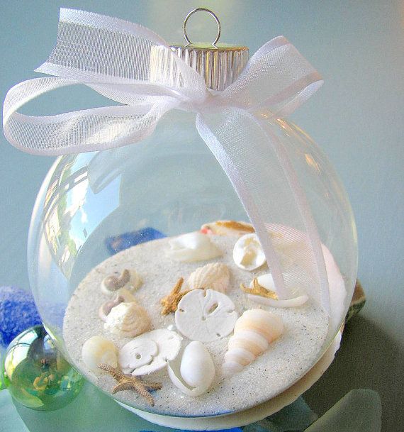 a glass ornament filled with sand and shells