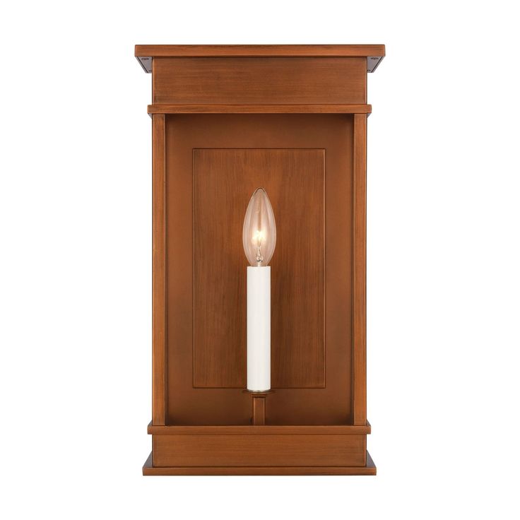 a wooden wall light with a white candle