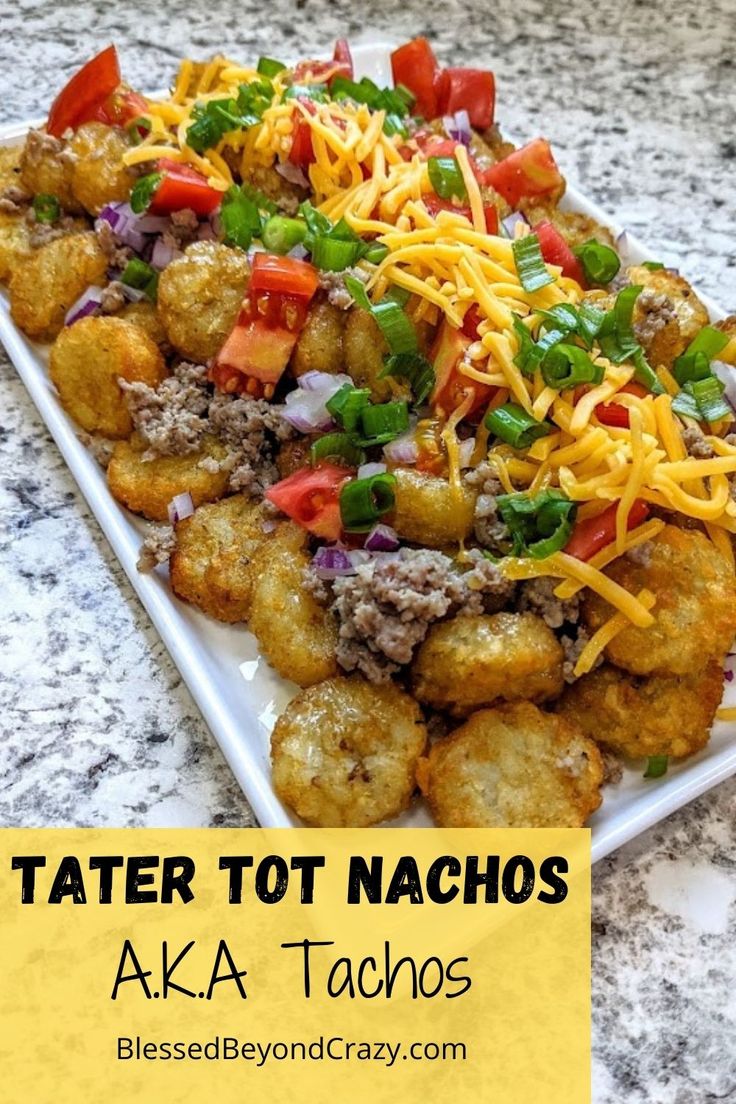 tater tot nachos on a white plate topped with cheese