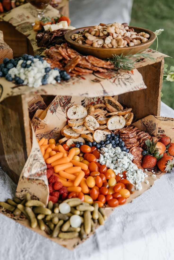 three tiered trays filled with different types of food on top of a table