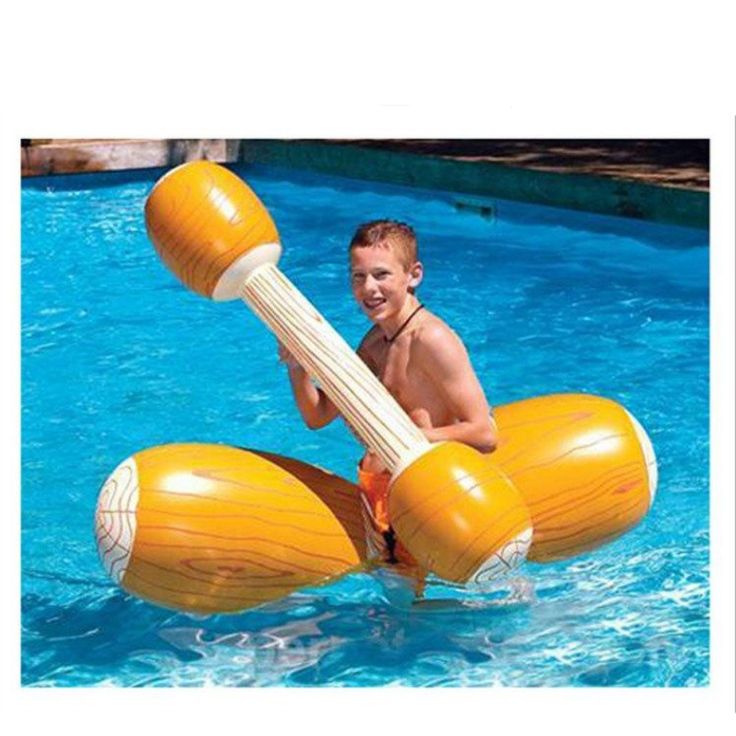 a young boy is riding on an inflatable raft at the edge of a swimming pool