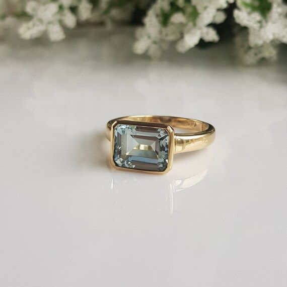 RING DETAILS:✪Design: Gold ring✪Gemstone: Natural aquamarine✪Gemstone color: Blue✪Gemstone size: 8x10 mm✪Gemstone shape: Emerald cut✪Gemstone transparency: Transparent✪Setting type: Bezel setting✪Metal type: 14k solid yellow gold✪Metal finish: Smooth shinyChoose your ring size from drop down menu and if you need any other preferred ring size please contact us.**********************************QUALITY OF MATERIALS:Metal: Most of our jewelry at JewelryMansion is made with precious metals like gold Bezel Aquamarine Ring, Square Gemstone Rings, Gold Aquamarine Engagement Ring, Emerald Cut Birthstone Ring In Timeless Style, Gold Emerald Cut Topaz Ring With Accent Stones, Gold Emerald-cut Topaz Ring With Accent Stones, 14k Gold Emerald Cut Topaz Ring, 14k Gold Sapphire Ring With Emerald-cut Center Stone, 14k Gold Emerald-cut Sapphire Ring With Center Stone