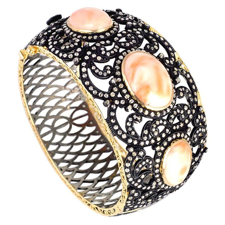 This magnificent 3 Oval shape coral with diamond leaf design around. This bangle is oval in shape and is openable on side and has safety clasp. 14kt:10.58gms Diamond:5.46cts Slv:35.61gms Coral:35.84cts Modern Bangle, Rings Luxury, Modern Bracelets, Leaf Jewelry, Hinged Bracelet, Diamond Bangle, Fantasy Jewelry, Sea Glass Jewelry, Gems Jewelry