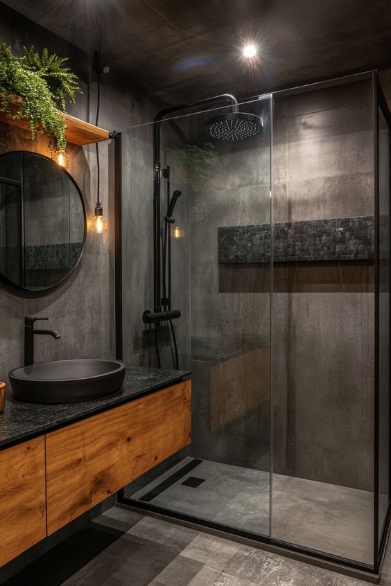 a bathroom with a glass shower door, sink and mirror on the wall next to it