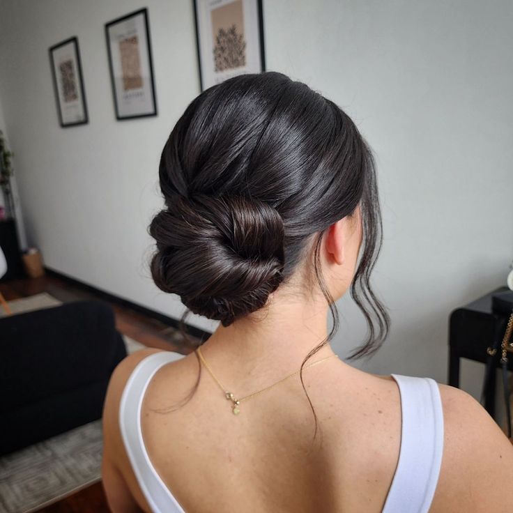 a woman with her hair in a low bun