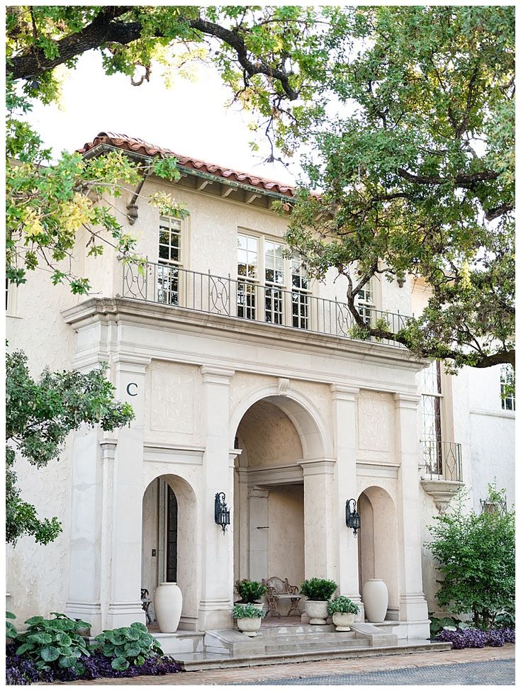 the front entrance to a large white house